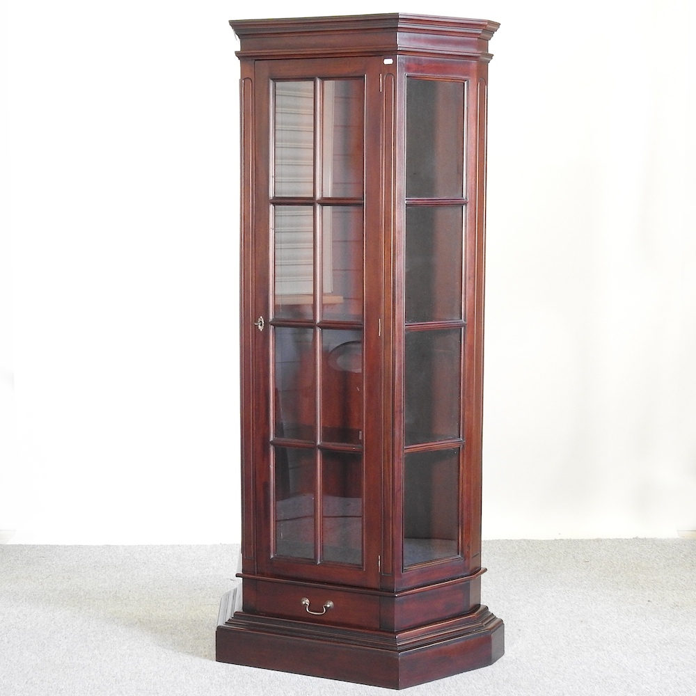 A reproduction glazed standing corner cabinet,