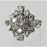 An unmarked diamond cluster ring, the central stone approximately 0.