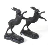 A pair of modern bronze models of boxing hares,