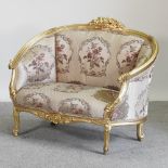 A French style gilt framed pink floral upholstered sofa,