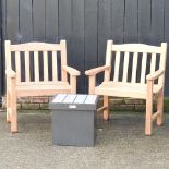 A pair of teak garden armchairs,