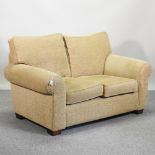 A beige upholstered sofa,