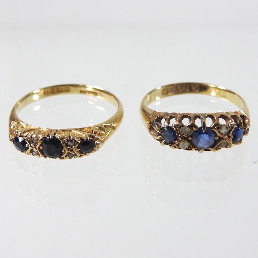 An 18 carat gold seven stone sapphire and diamond half hoop ring, sizes M,