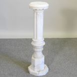 A white carved marble pedestal,
