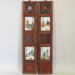 A pair of modern Chinese wooden plaques, inset with porcelain panels,