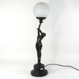 An Art Deco style figural table lamp, with a globe shade,