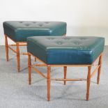 A pair of green leather upholstered shaped stools,