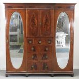 An Edwardian mahogany and inlaid combination triple wardrobe,