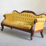 A large Victorian mahogany and yellow upholstered show frame sofa,