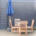 A woven garden table, with a glass top, together with a set of four teak garden chairs,