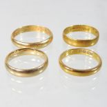 Three 22 carat gold wedding bands, 9.8g gross, together with an 18 carat gold wedding band, 3.