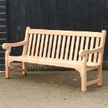 A teak slatted garden bench, with a loose cushion,