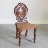 A Victorian oak hall chair