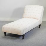 A Victorian cream upholstered chaise longue,