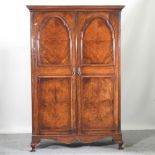 A 1920's walnut double wardrobe, with a fitted interior, by Maple & Co,