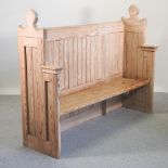An early 20th century Gothic style pitch pine pew,