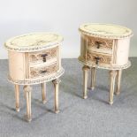 A pair of cream painted bedside chests, of oval shape,