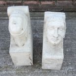 A near pair of medieval style reconstituted stone corbels, each in the form of a merchant's head,