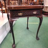 An Edwardian mahogany envelope card table, on cabriole legs and claw and ball feet,