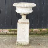 A reconstituted stone urn, on stand,