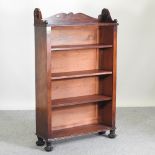 A Regency mahogany dwarf open bookcase, on reeded feet,