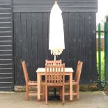 A teak garden table, 90cm, together with a set of four chairs,