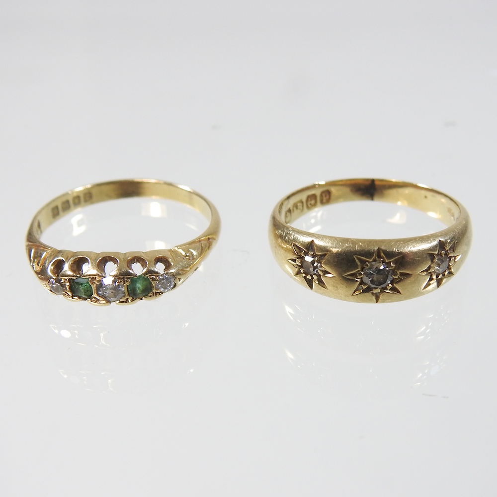An 18 carat gold three stone diamond ring, size M,