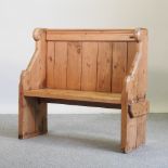 An early 20th century Gothic style pitch pine pew,