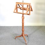 A light oak duet stand, on a tripod base,