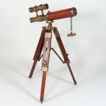 A reproduction telescope, on a tripod stand,