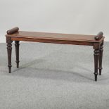 A Regency mahogany scroll end window seat, on turned legs,