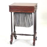 A Regency mahogany ladies work table, on scrolled feet,