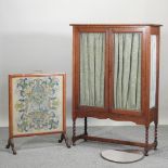A 1920's oak glazed cabinet, 96cm, together with a tapestry fire screen,