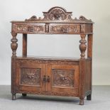 An early 20th century carved oak buffet,