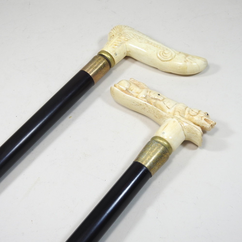 A modern novelty walking stick, with a carved bone handle, together with another,