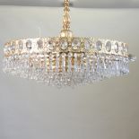 A gold painted metal and cut glass chandelier,
