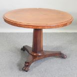 A 19th century mahogany circular breakfast table, on lion's paw feet,