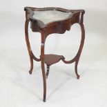 An Edwardian mahogany shaped triangular bijouterie table, on cabriole legs, united by an undertier,