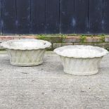 A pair of reconstituted stone planters, in the form of baskets,