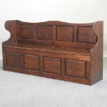 A stained pine box settle,