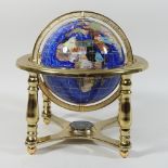 A polished hardstone terrestrial table globe on a brass mount,