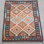 A kelim rug, with geometric design, on a black ground,