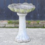 A reconstituted stone bird bath,