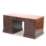 A reproduction mahogany pedestal desk, with a red inset top,