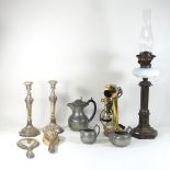 A pair of silver plated candlesticks, together with an oil lamp, a pewter part tea service,