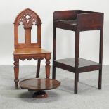 A Victorian Gothic style oak hall chair, together with a 20th century mahogany lazy Susan,