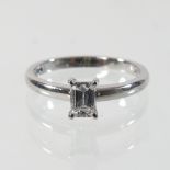 A modern platinum and diamond emerald cut diamond ring, approximately 0.4 carats, 3.