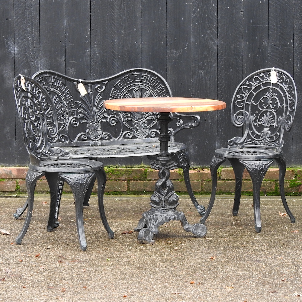 A black painted garden bench, 102cm, together with a pair of chairs,