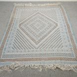 A kelim rug, with geometric design, on a blue ground, 240 x 157cm,