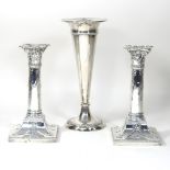 A pair of Edwardian silver table candlesticks, each in the form of a column,